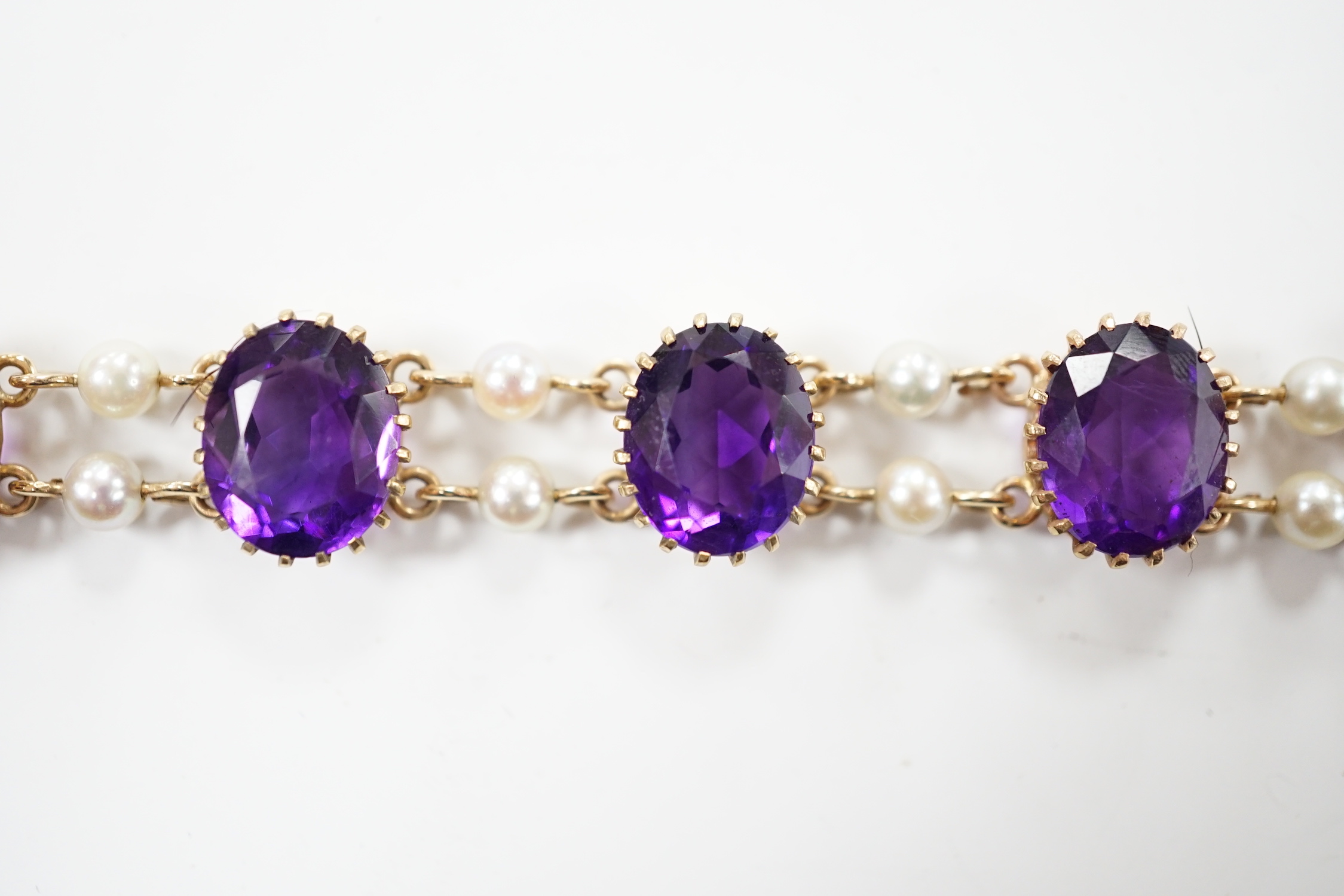 A 1970's Edwardian style 9ct gold amethyst and cultured pearl cluster set bracelet, 17.5cm, gross weight 15.9 grams.